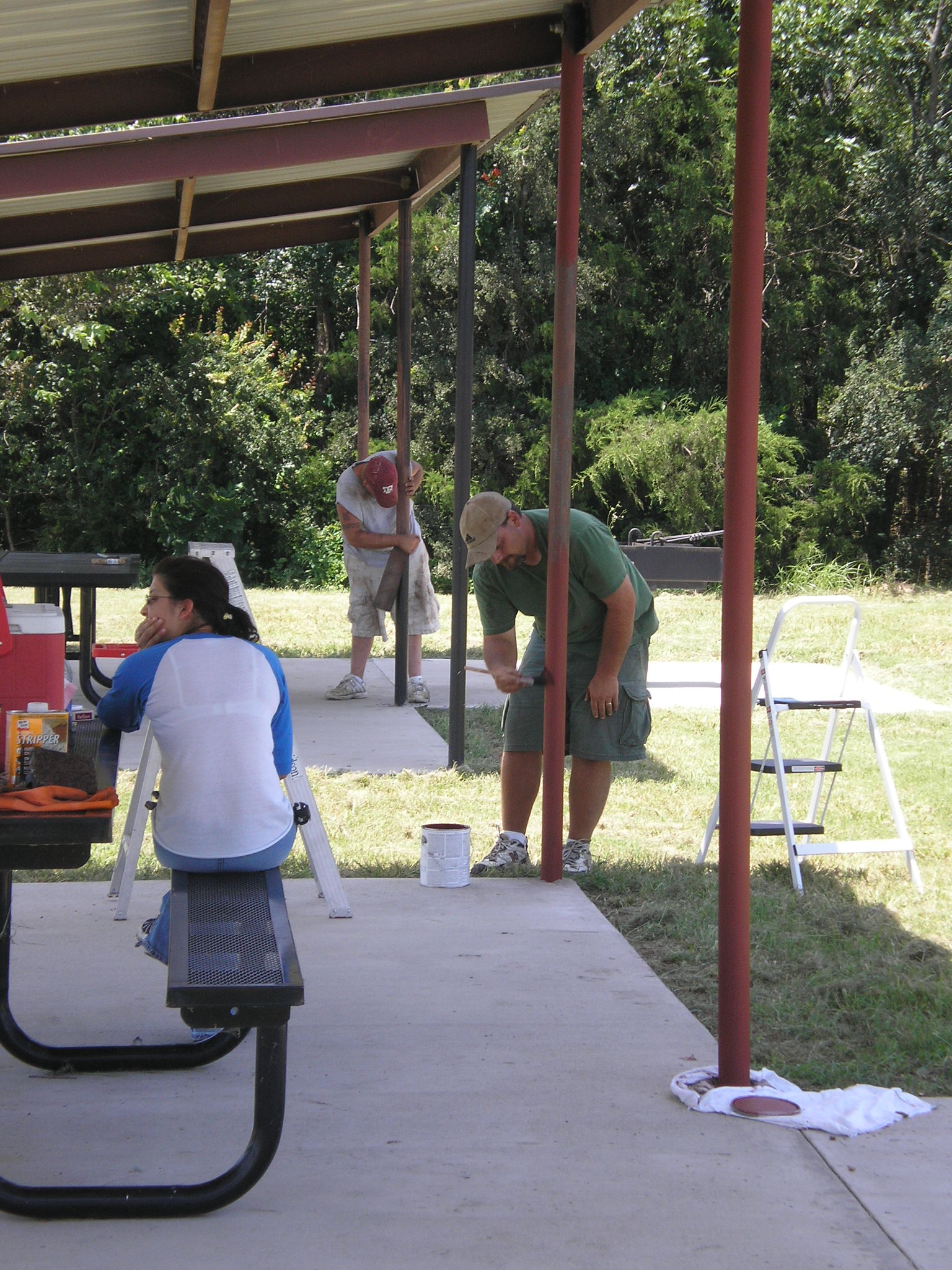Volunteers painting picnic area covers at Stilling Basin